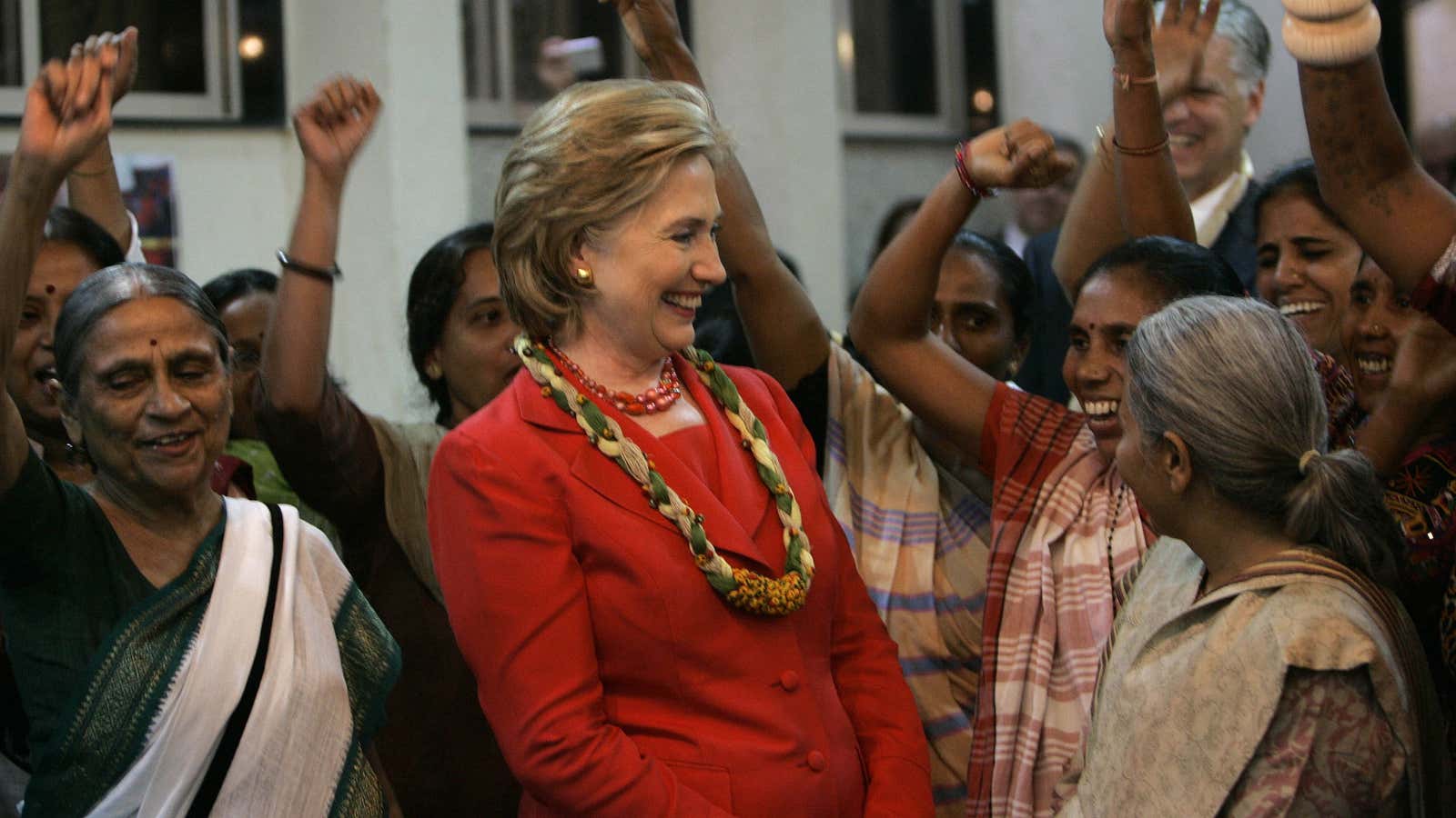 Clinton, center, smiles as she interacts with members of Self Employed Women’s Association, a non-government organization, in Mumbai, India, July 18, 2009.