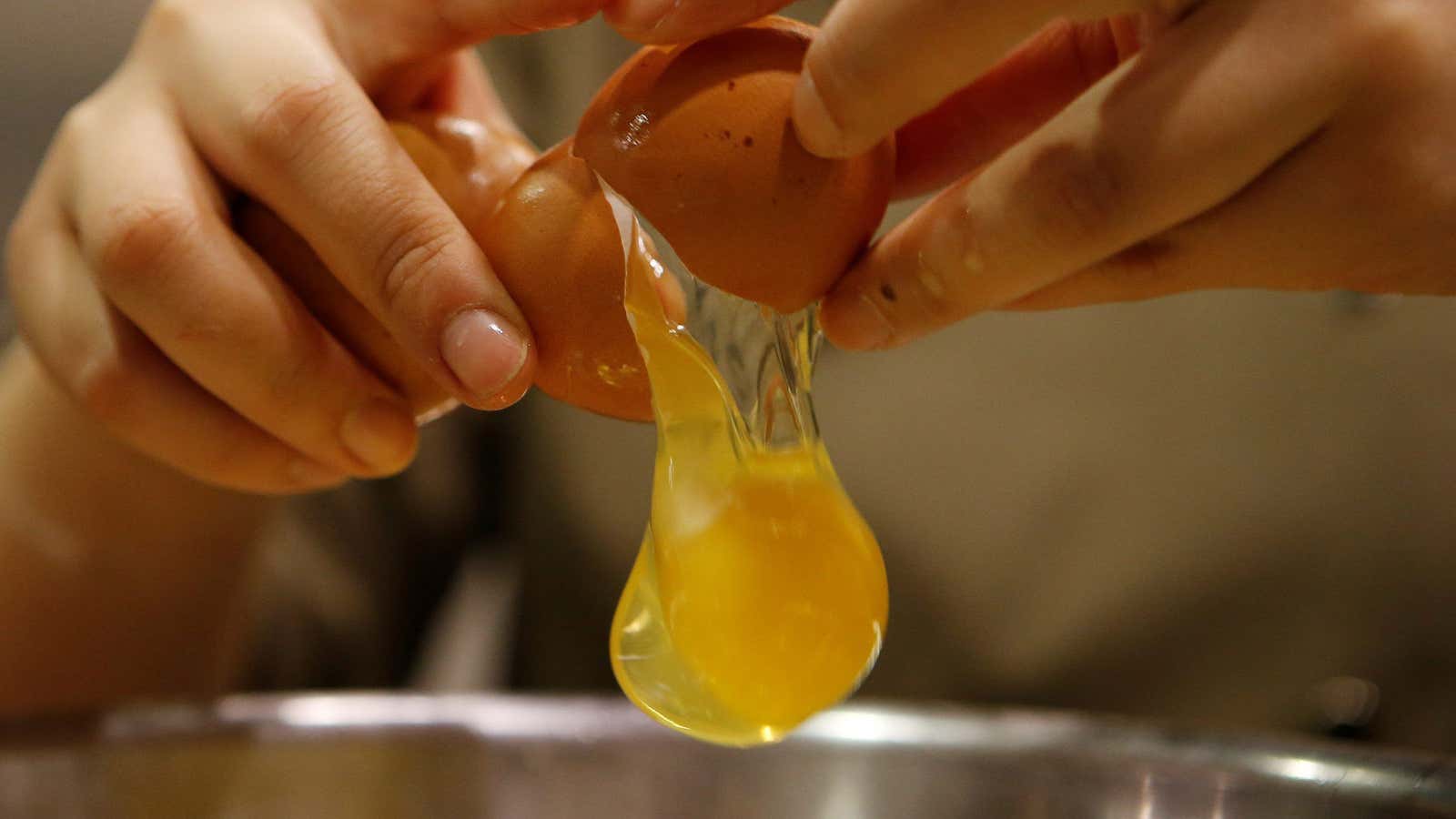 A chef breaking an egg