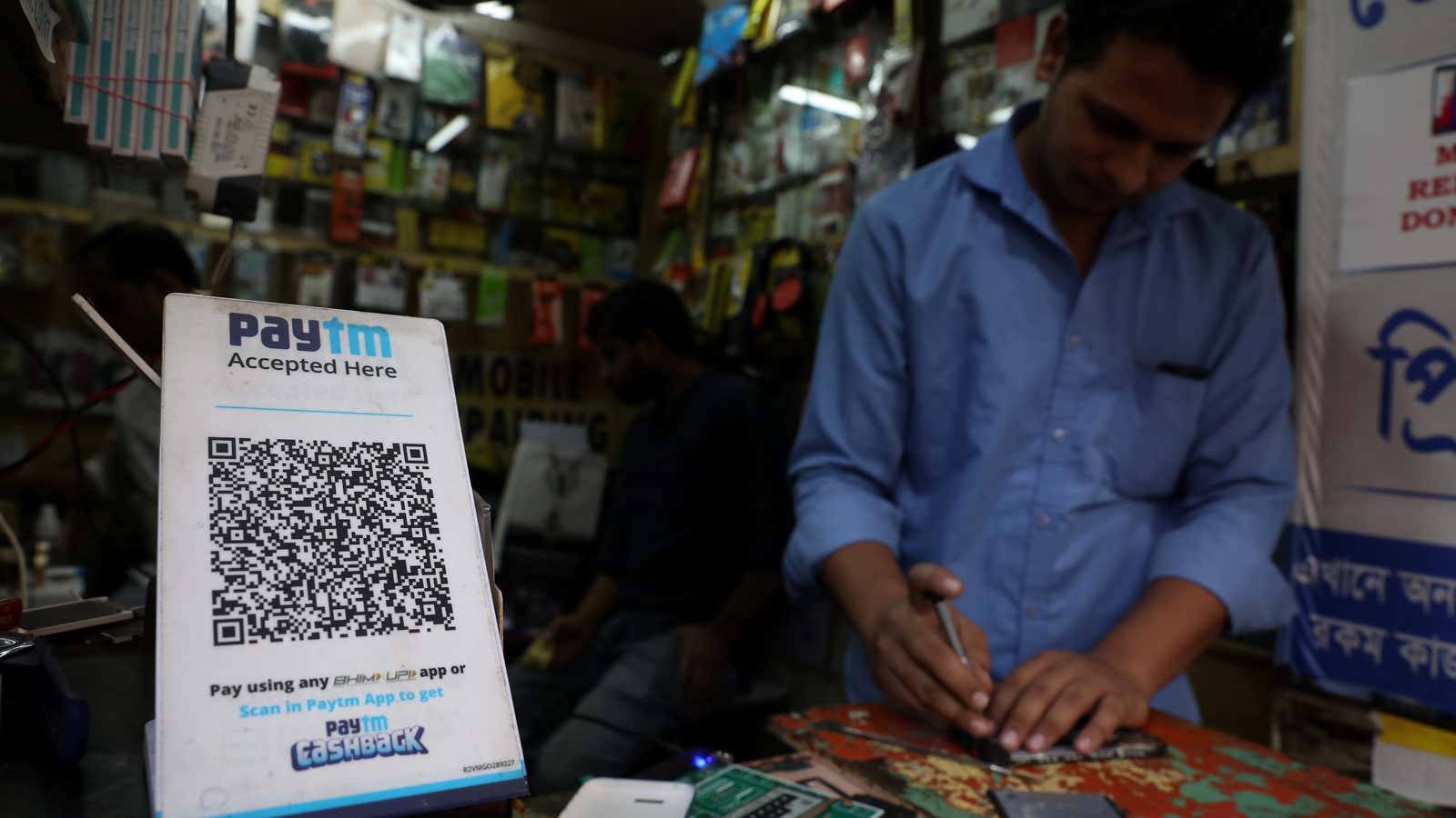 A QR code of Paytm is seen at a mobile repairing shop in Kolkata, India, November 9, 2021.