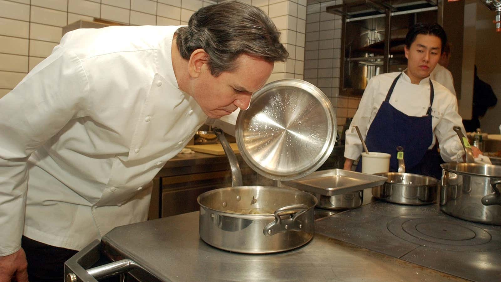 Per Se owner Thomas Keller checks for signs of burning.