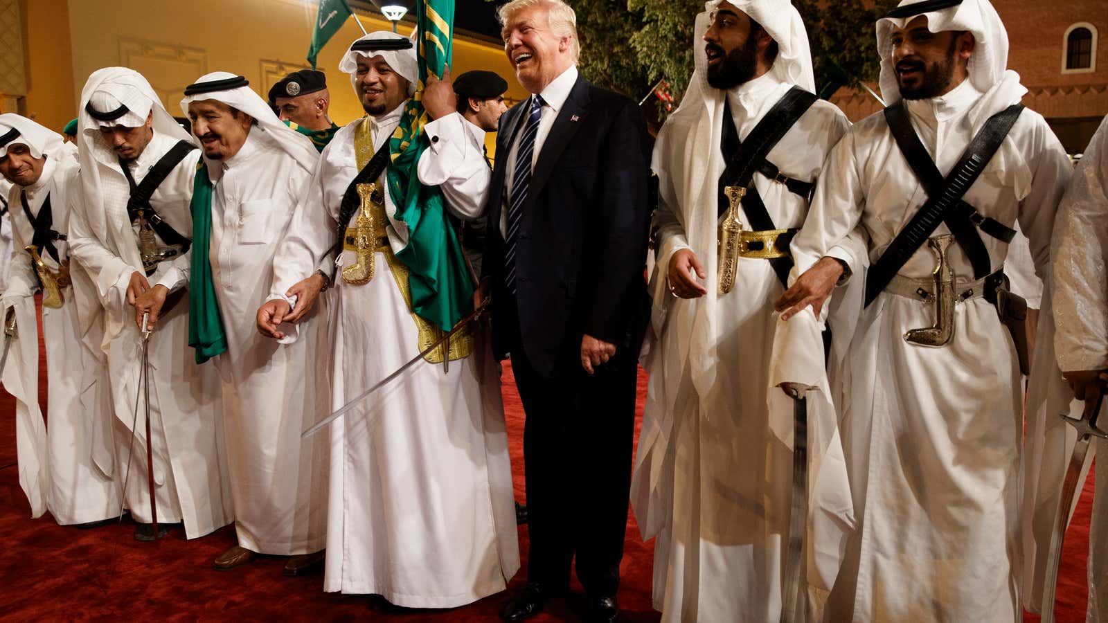 President Donald Trump holds a sword and dances with traditional dancers during a welcome ceremony at Murabba Palace, Saturday in Riyadh.