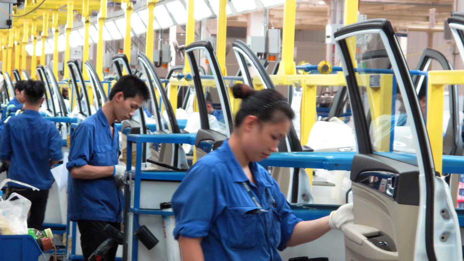 Employees work at a production line inside a factory of Saic GM Wuling, in China.