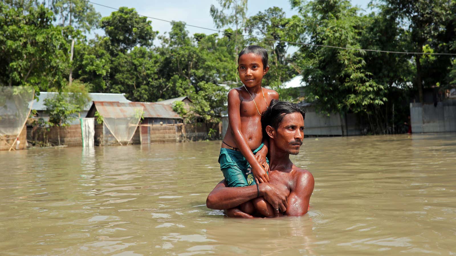 Wading through water in Jamalpur, Bangladesh, on July 21.