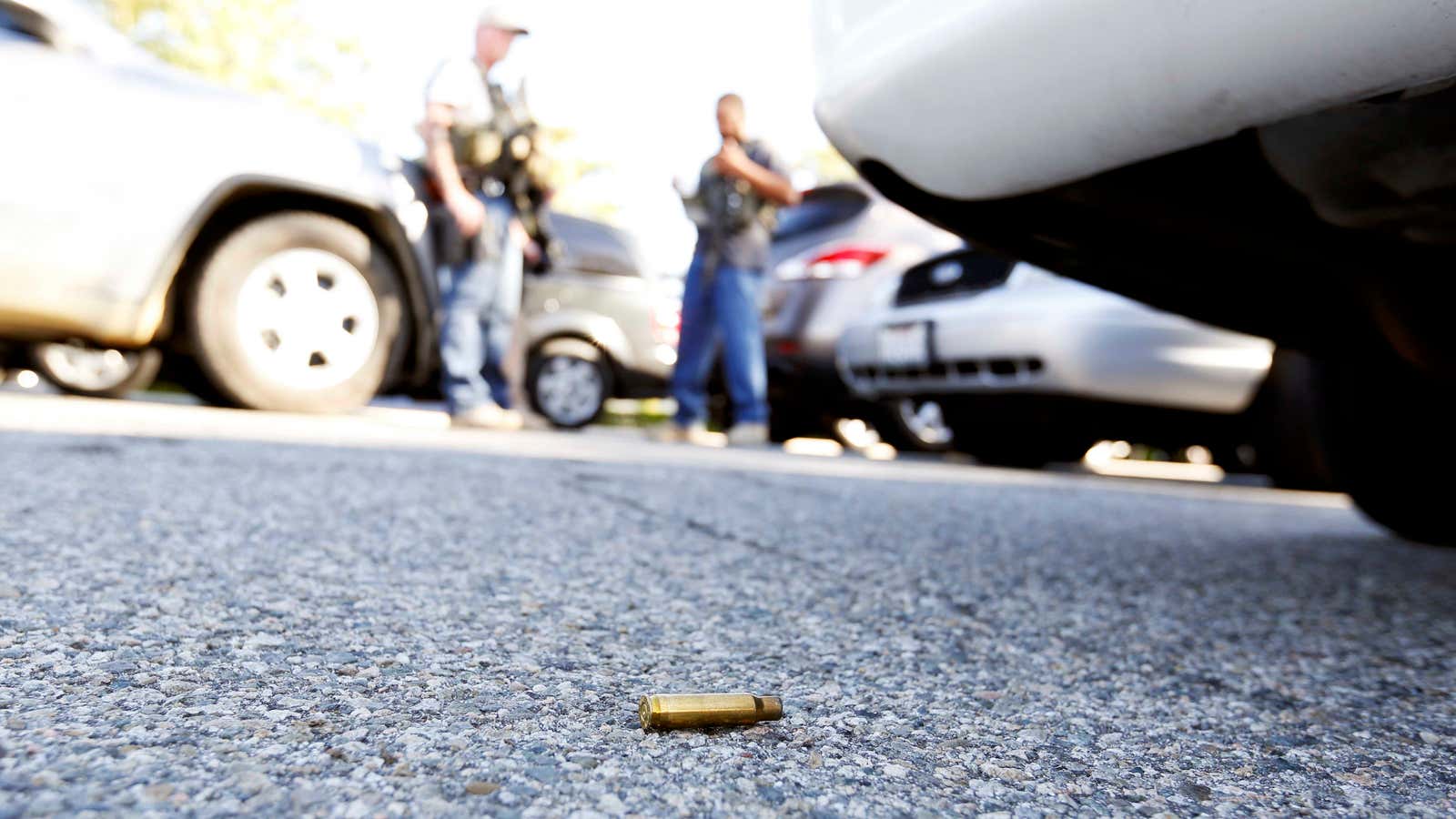 A spent cartridge lies on the ground as police officers secure the area after at least one person opened fire at a social services agency…