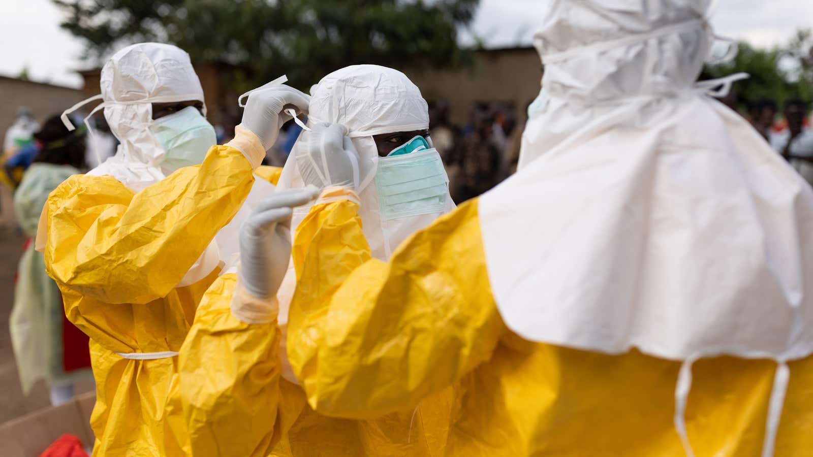 Red Cross workers don PPE prior to burying a 3-year-old boy suspected of dying from Ebola on October 13, 2022 in Mubende, Uganda.