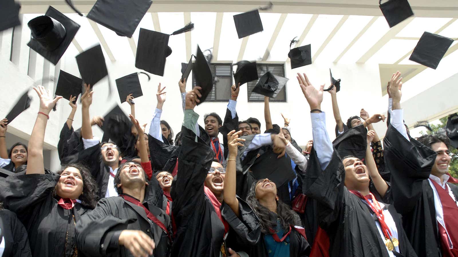 Students of Nalsar University of Law fling their graduation caps after the conclusion of the 5th Annual Convocation at their college premises, on the outskirts of Hyderabad, India, Saturday, July 21, 2007. (AP Photo/Mahesh Kumar A)