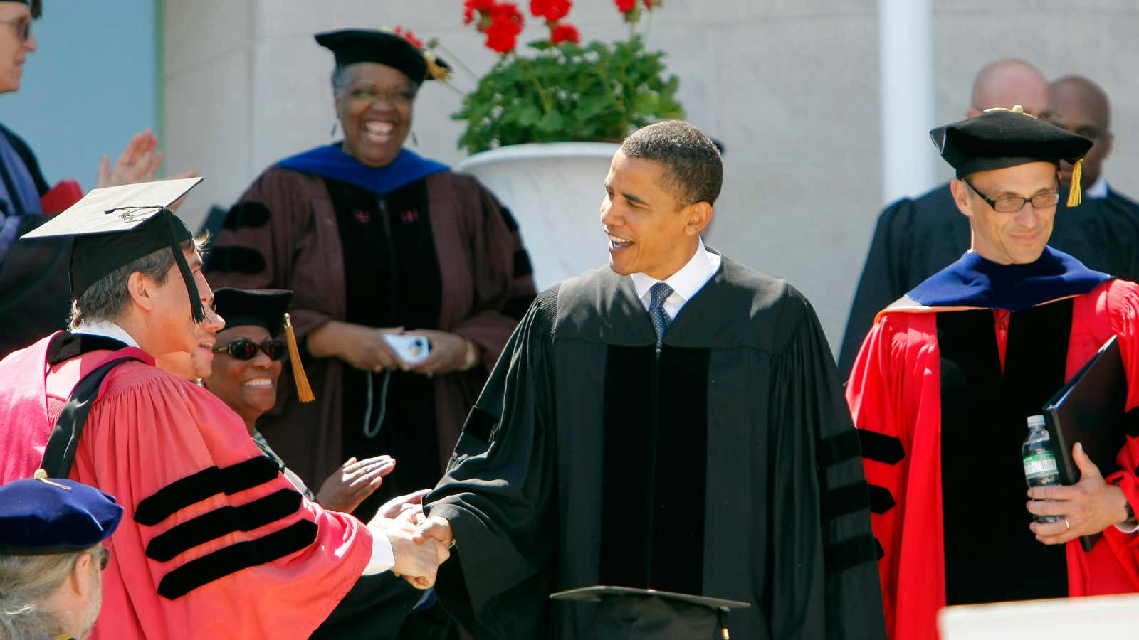 Barack Obama is greeted by Wesleyan faculty members before addressing the graduating class in 2008.