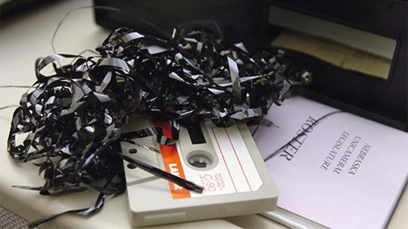 A jammed cassette, with its tape outside of the plastic case, is seen at the desk of transcriber supervisor Debbie Smith, at the state Capitol,…