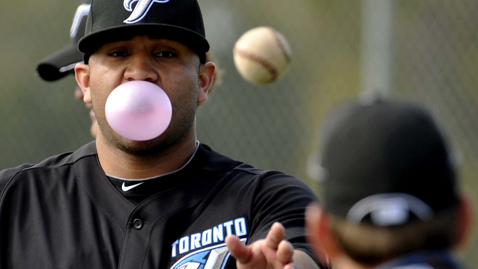 Toronto Blue Jays pitcher Ricky Romero blows a bubble while tossing a ball during practice at their MLB American League spring training facility in Dunedin, Florida, February 22, 2011.    REUTERS/Mike Cassese (UNITED STATES – Tags: SPORT BASEBALL) – GM1E72N05C501