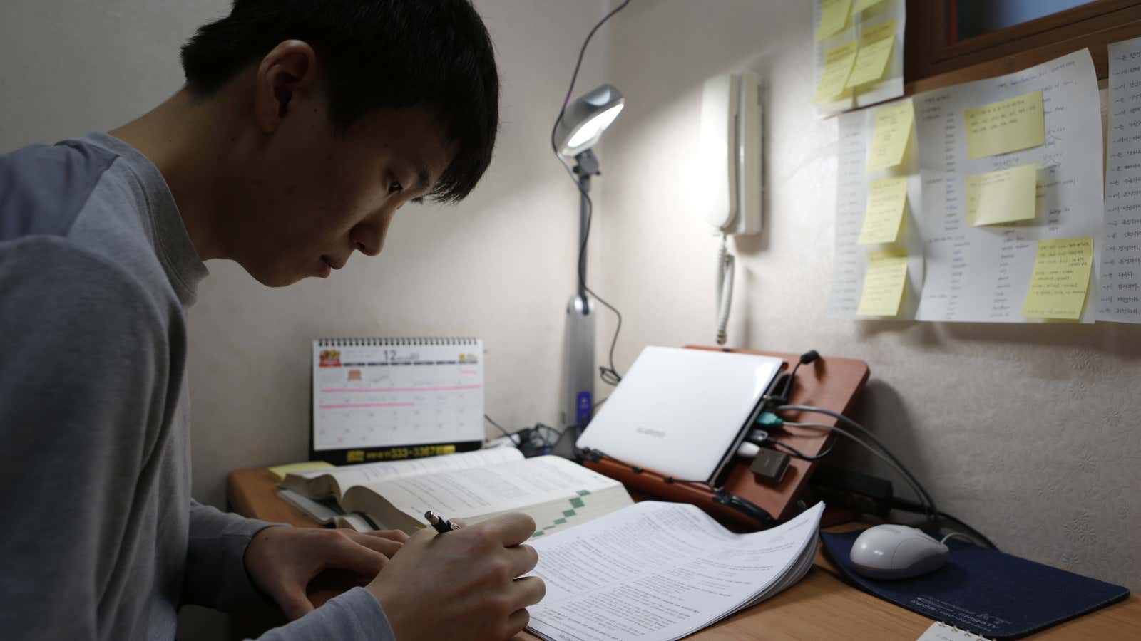 Kim Sa-myeong, 27, studies in his small room called a ‘Goshiwon’ in one of the many private dorms that house students cramming for exams in…