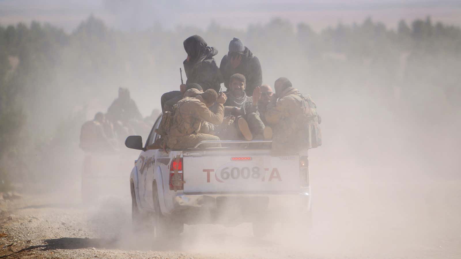 SDF fighters ride a pick-up truck near al-Shadadi, Syria, on February 18, 2016.