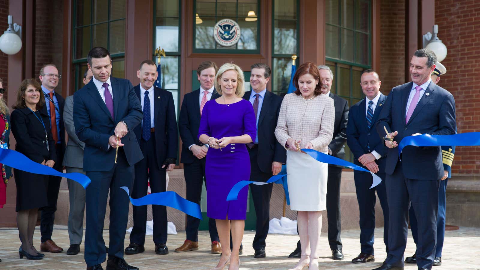 Nielsen, in blue, stands next to acting deputy secretary Claire Grady, who has also departed.