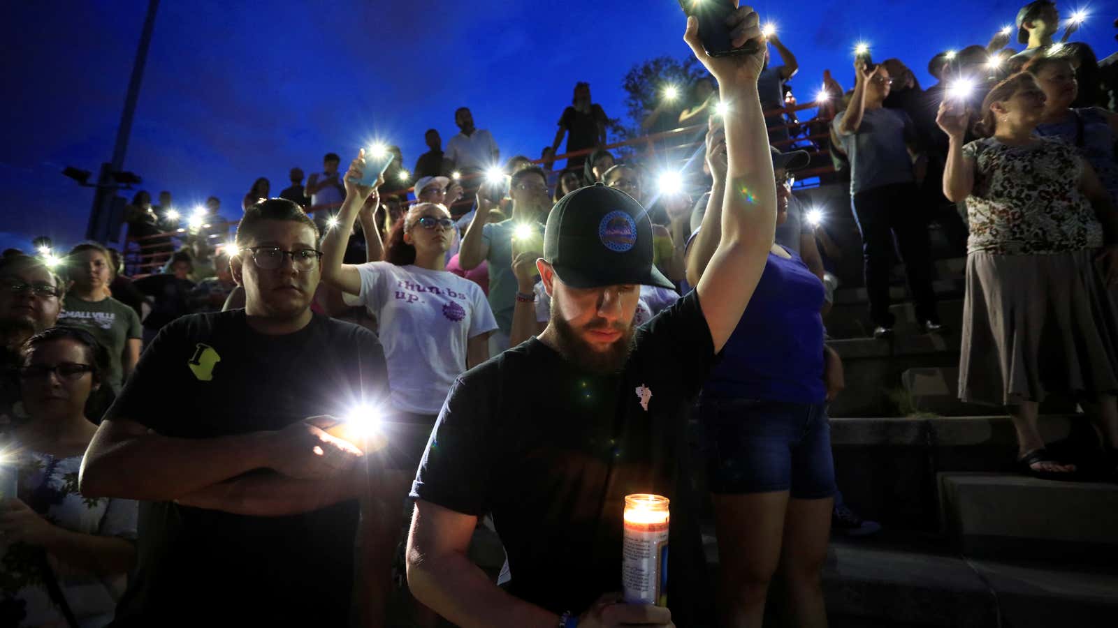 Mourners take part in a vigil at El Paso High School after a mass shooting at a Walmart store in El Paso.