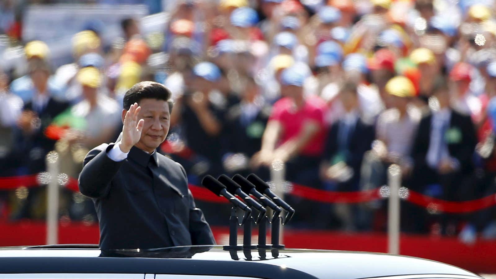 Chinese President Xi Jinping waves as he reviews the army, at the beginning of the military parade marking the 70th anniversary of the end of…