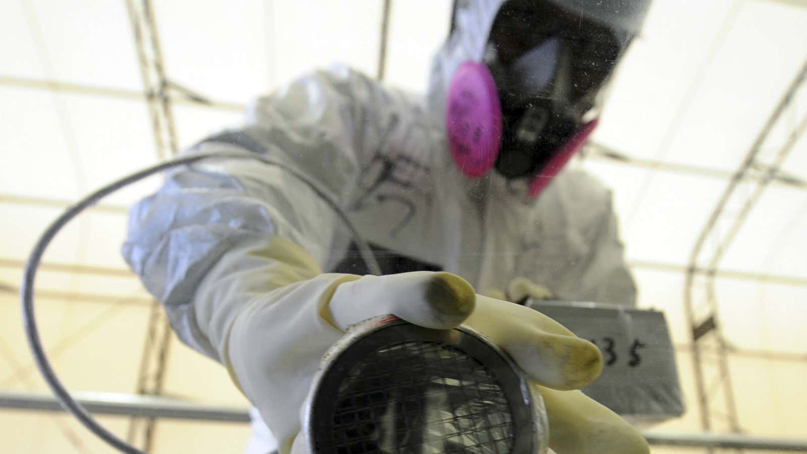 A worker takes radiation readings at Fukushima.