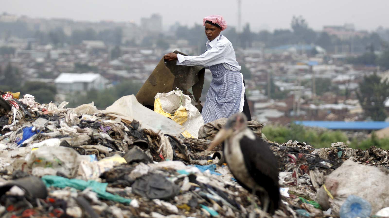 A woman scavenges for recyclable materials at the Dandora dumping site on the outskirts of Nairobi.