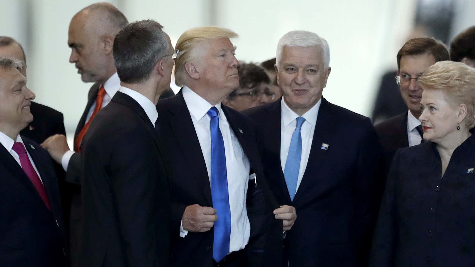 Trump pushes to the front of a photo-op at the NATO summit in Brussels.