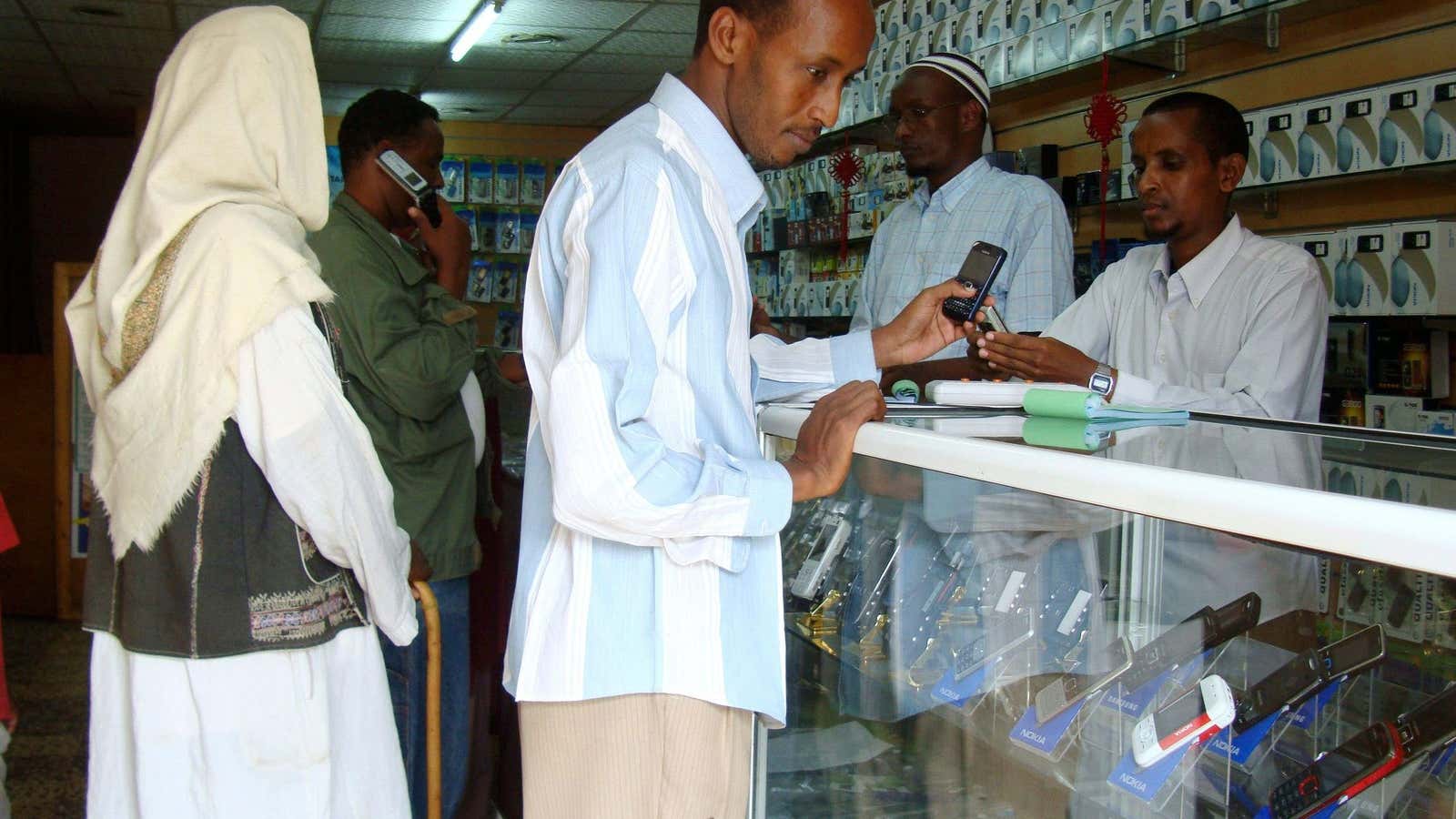 Residents shop for mobile phone handsets at a shopping center in Mogadishu