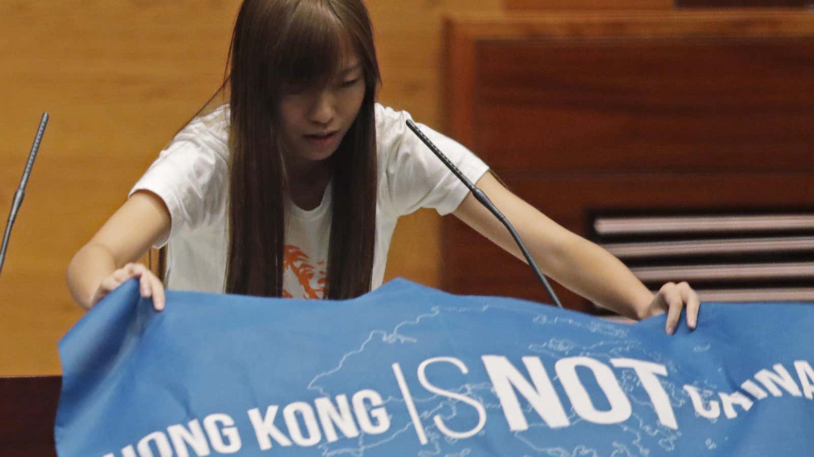 Yau Wai-ching displays a banner with words reading “Hong Kong is not China” as she takes her oath in the new Legislative Council in Hong Kong, Oct. 12, 2016.