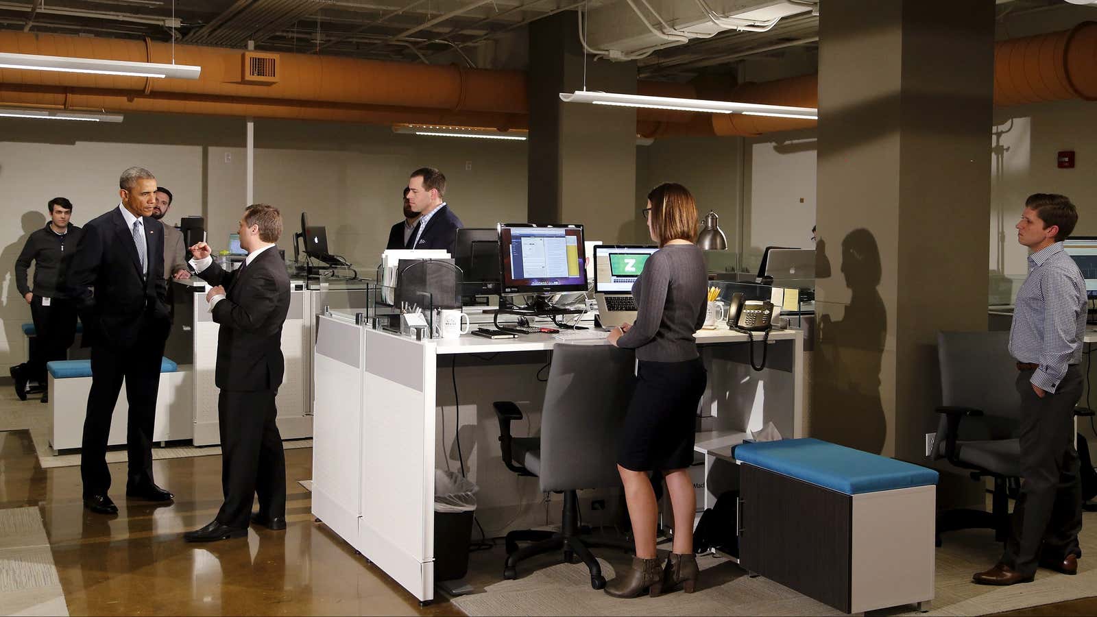 U.S. President Barack Obama (2nd L) talks with software development company InDatus President Phil Hawkins on a tour of the tech firm in Louisville, Kentucky April 2, 2015.