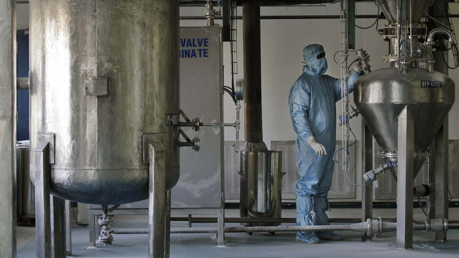 A worker checks vital signs at a pharmaceutical plant in India