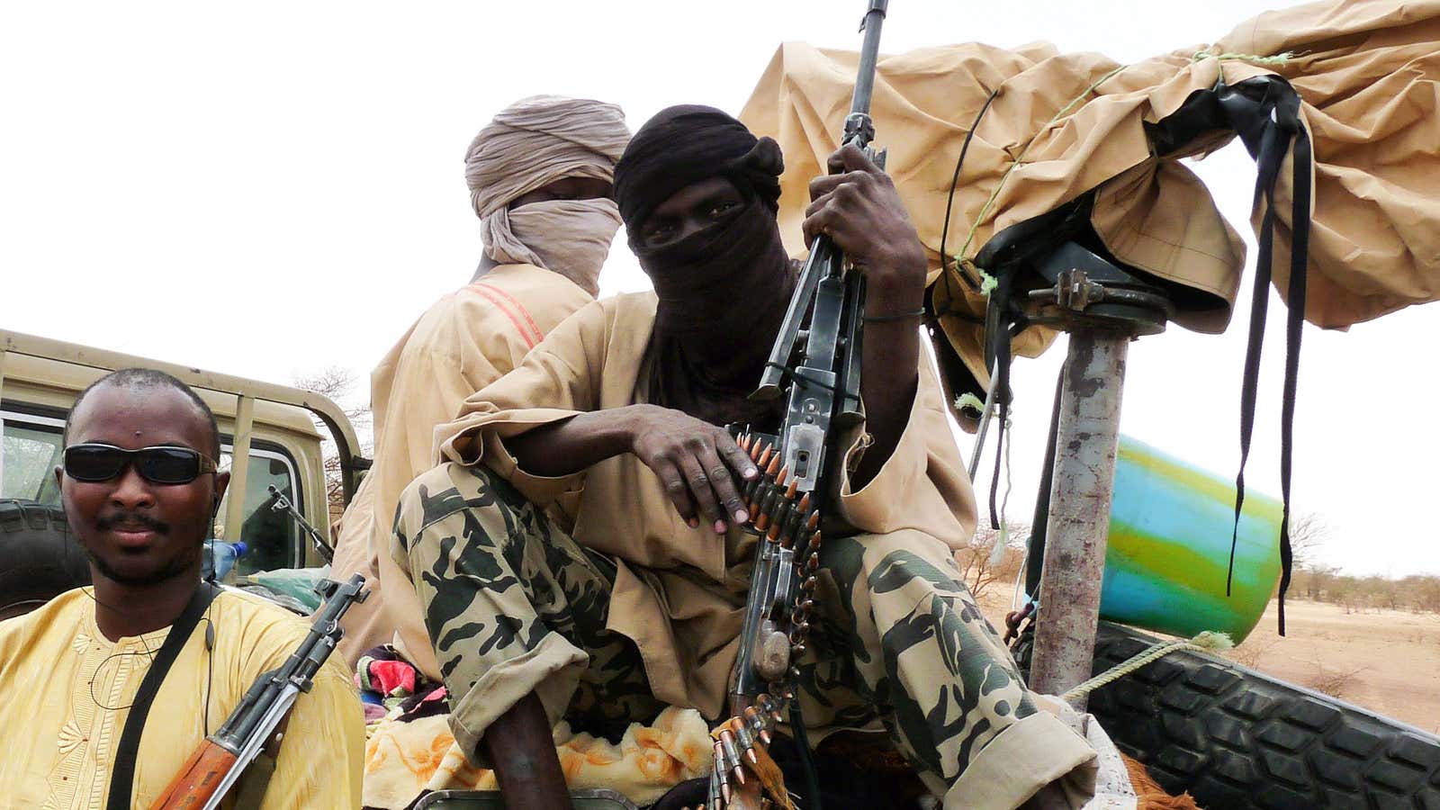 Militiaman from the Ansar Dine Islamic group sit on a vehicle in Gao in northeastern Mali