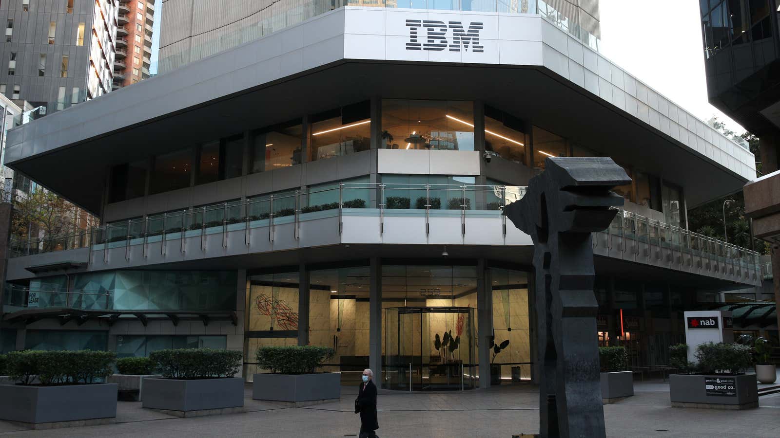 A man wearing a protective mask walks past an office building with IBM logo amidst the easing of the coronavirus disease (COVID-19) restrictions in the…