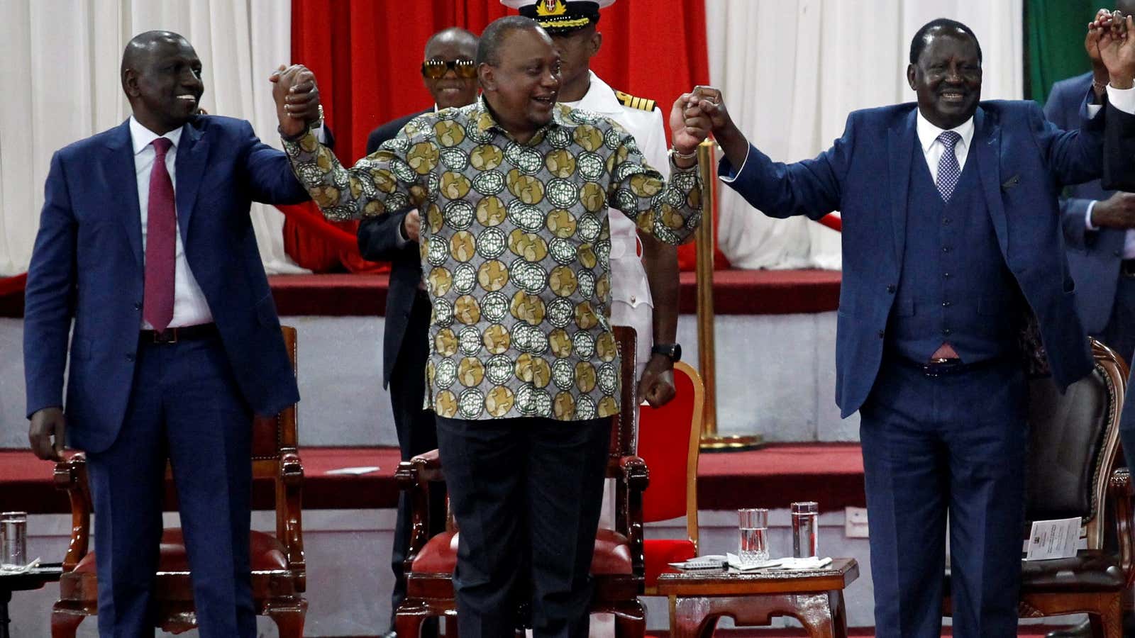 Kenya’s president Uhuru Kenyatta holds hands with Kenyan deputy [resident William Ruto and opposition leader Raila Odinga during the launch of the Building Bridges Initiative (BBI) report  in Nairobi, Kenya, Nov. 27, 2019.