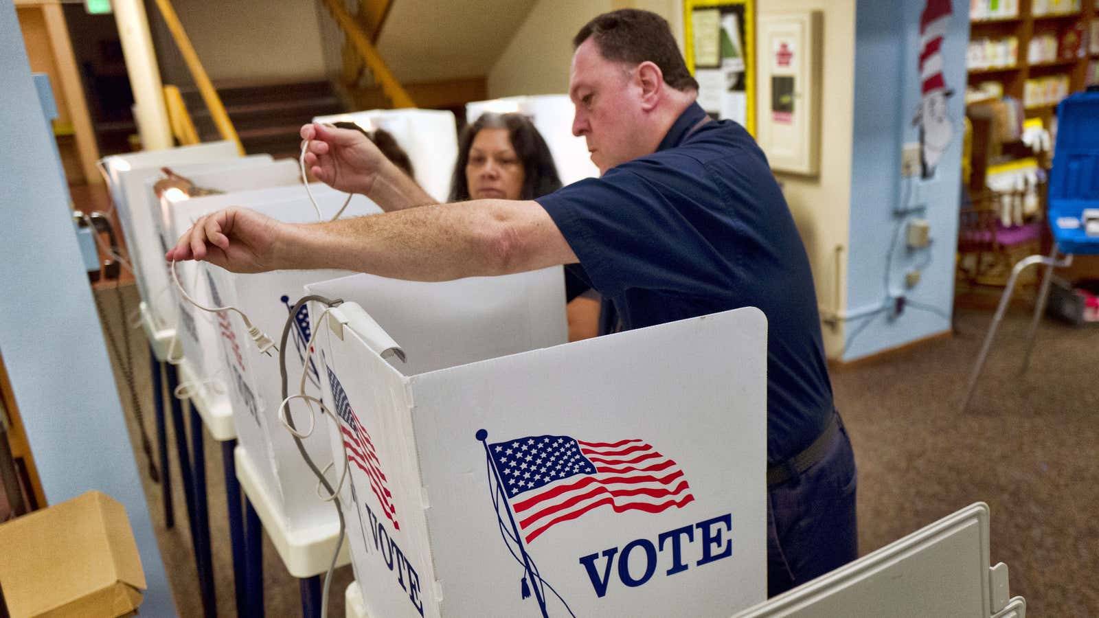 Poll workers prepare voting booths for a California primary election—held on a Tuesday, per tradition.