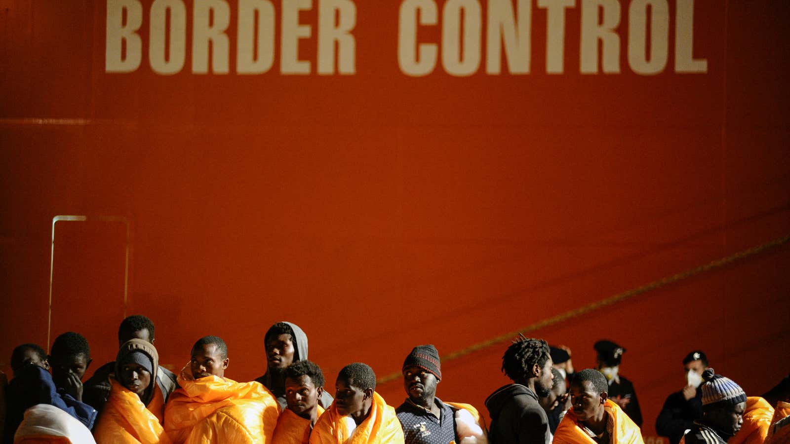 Migrants stand on the dock after disembarking from the Norwegian vessel Siem Pilot in the Sicilian harbor of Palermo.