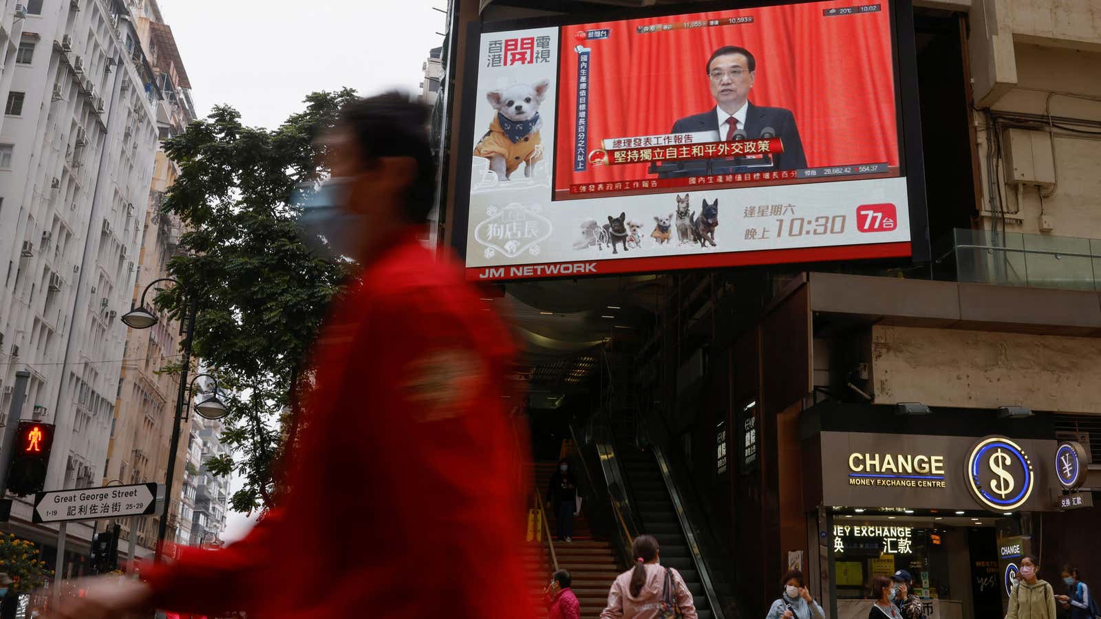 A TV screen showing news over the opening session of the National People’s Congress (NPC), is seen in Hong Kong, China March 5, 2021. REUTERS/Tyrone…