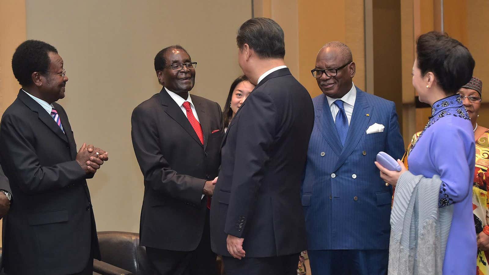 Zimbabwe’s Robert Mugabe shakes hands with Chinese president Xi Jinping.