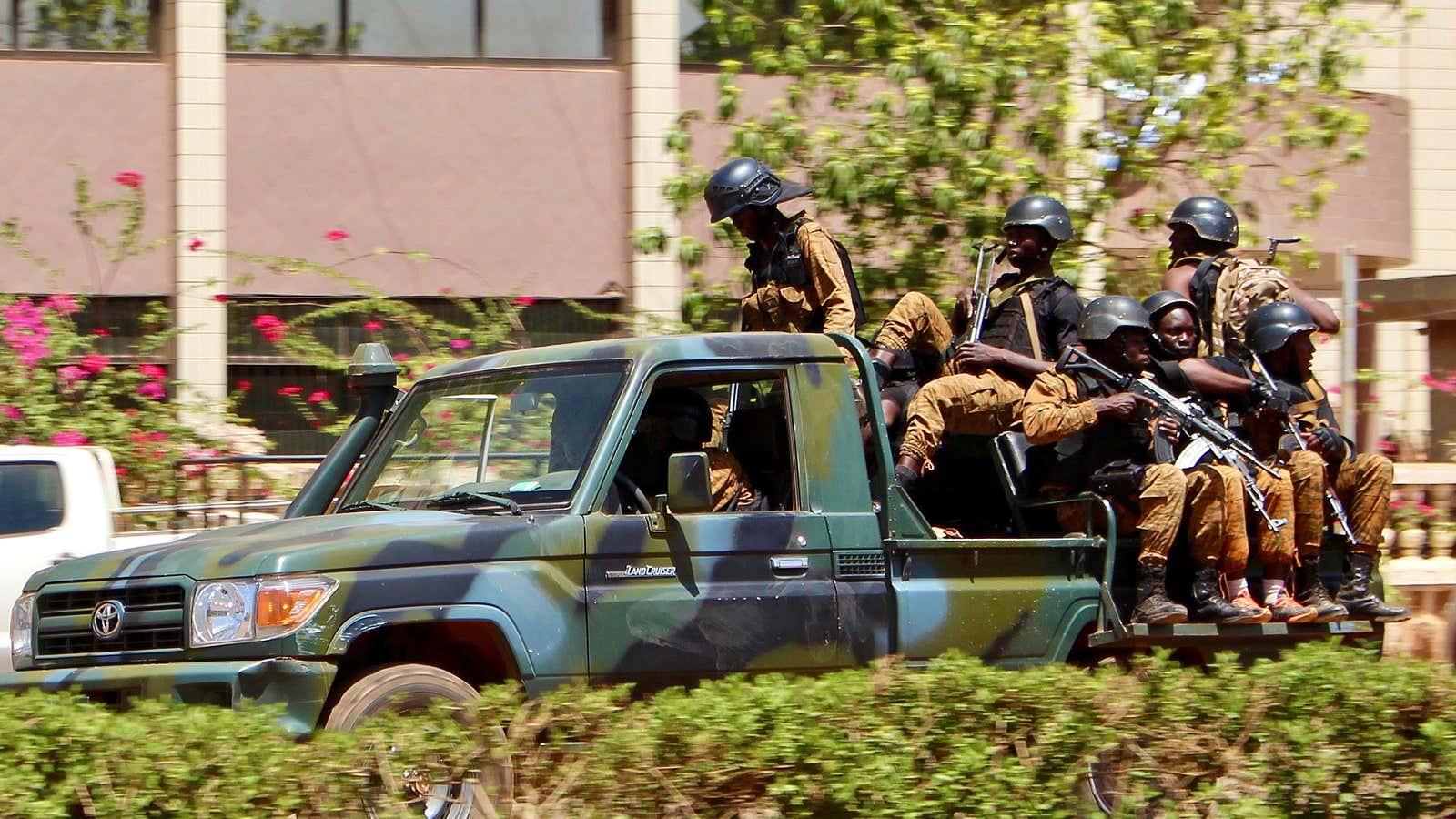 Troops ride in a vehicle near the French Embassy in central Ouagadougou, Burkina Faso, Mar. 2, 2018 after gunfire and explosions rocked Burkina Faso’s capital.