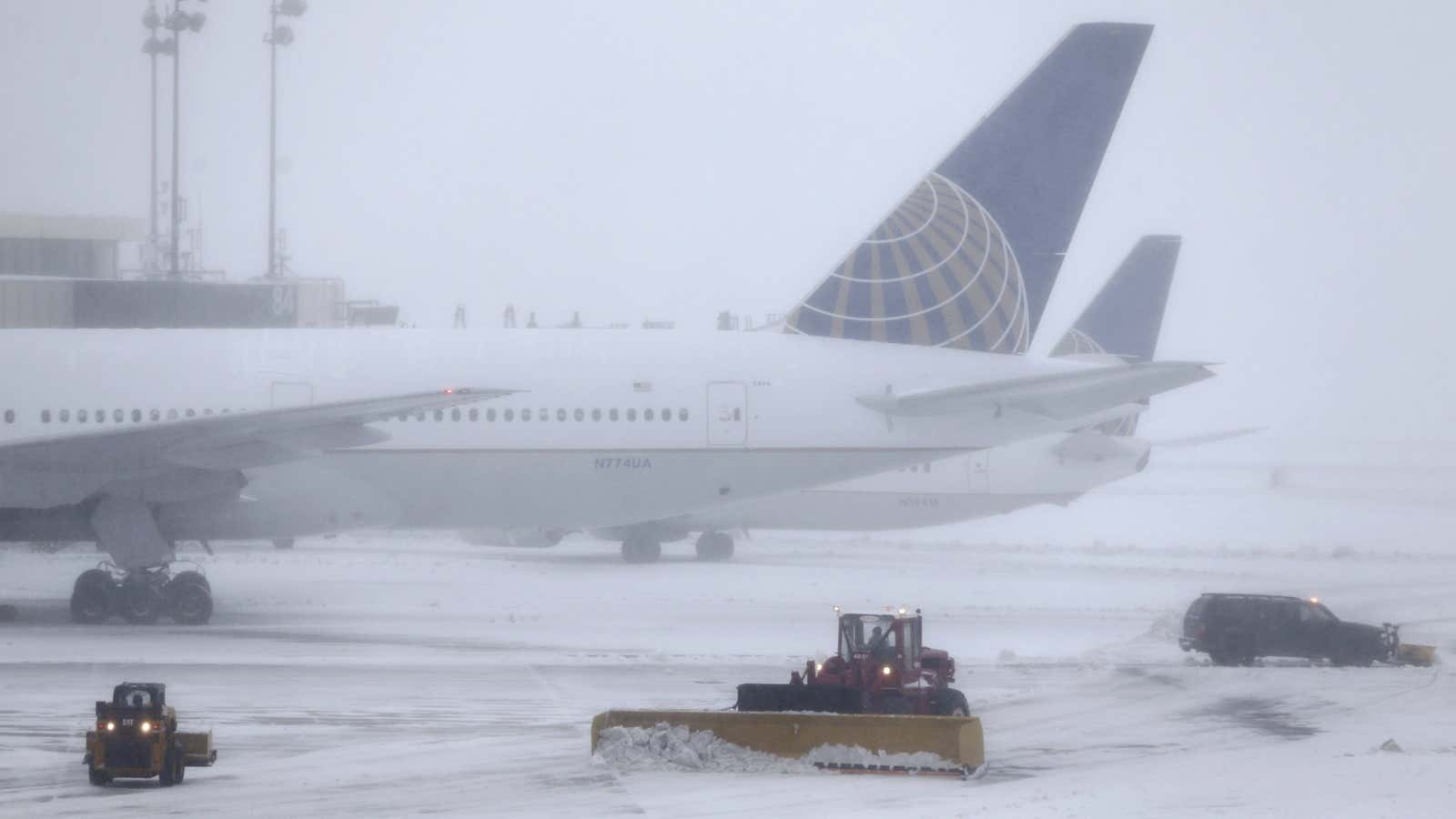 Snowplows work to keep the grounds clear at Newark Liberty International Airport in Newark, N.J., Tuesday, March 14, 2017. A storm pounded the Northeast with more than a foot of snow in places Tuesday, paralyzing much of the Washington-to-Boston corridor after a remarkably mild February had lulled people into thinking the worst of winter was over.