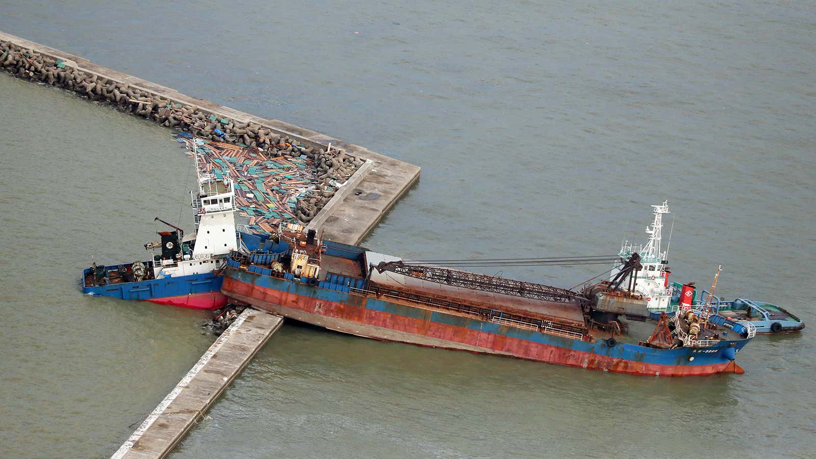 A damaged ship stranded on a seawall a day after Jebi hit Nishinomiya.