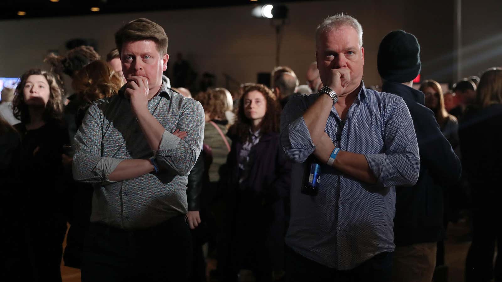 Supporters of Democratic presidential candidate former Vice President Joe Biden watch television results at his rally in Des Moines, Iowa on Feb. 3, 2020.