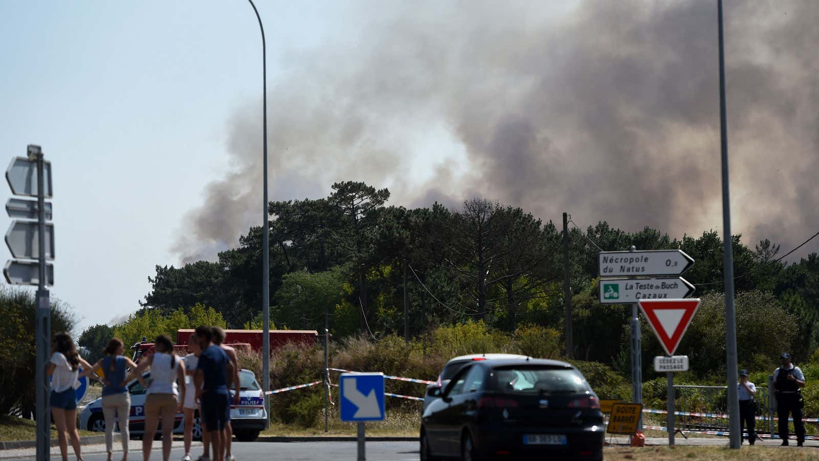 Members of the public observe a fire from La Teste-de-Buch, southwestern France, on July 16, 2022.