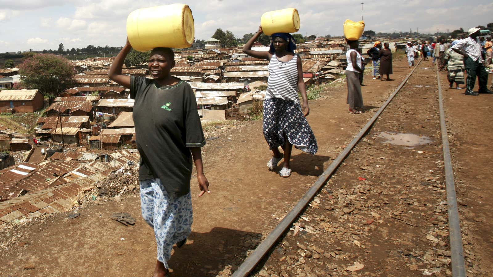 Women carry jerry-cans of water on their heads as they walk to Kibera slums in Kenya’s capital Nairobi.