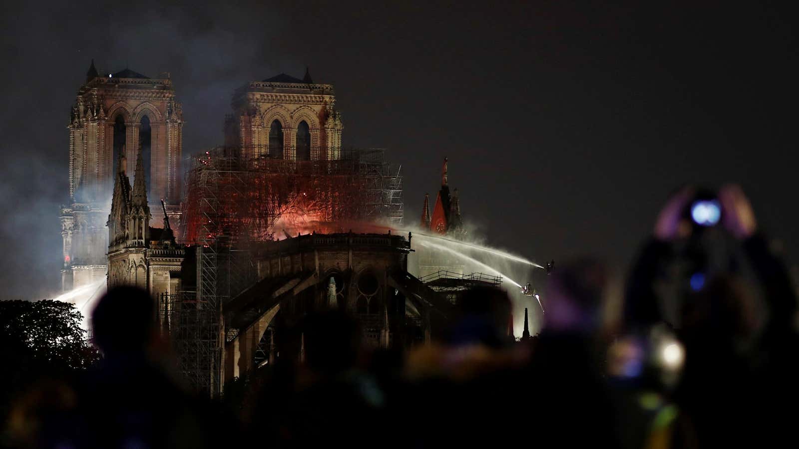 Firefighters douse flames in the burning cathedral.