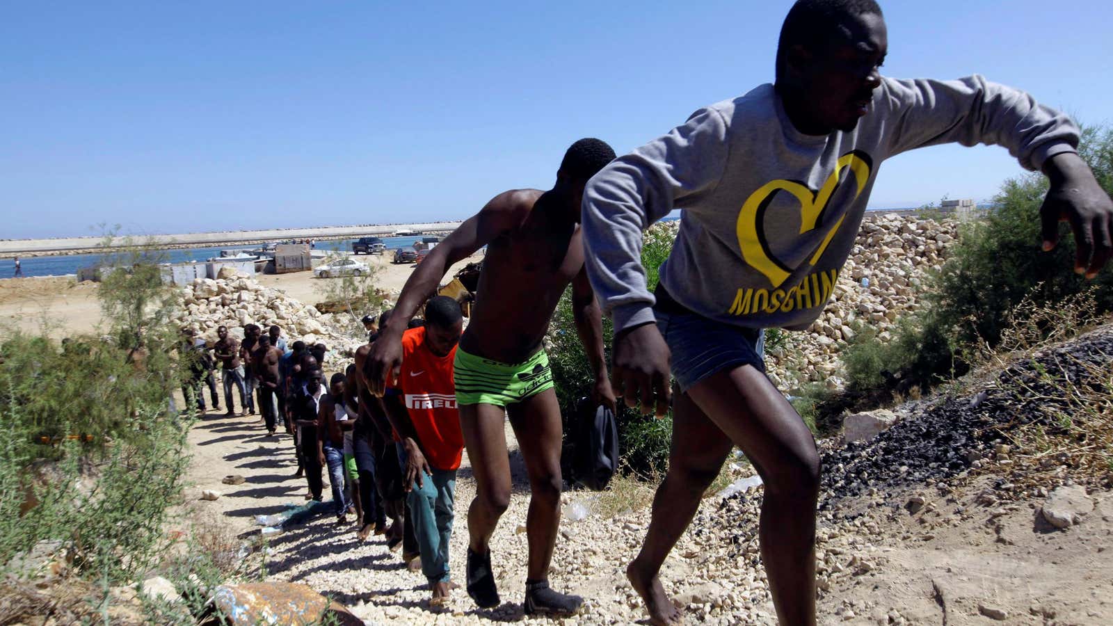 Migrants rescued from drowning boat in Tripoli.
 (Reuters/Ismail Zetouni)