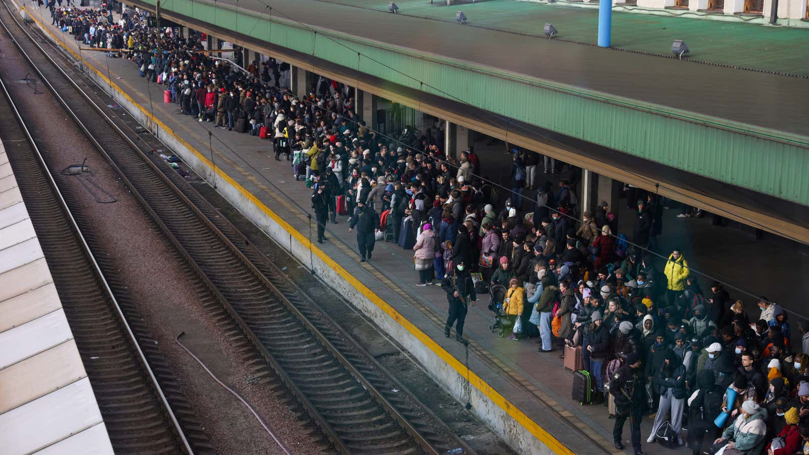 People wait to board an evacuation train from Kyiv to Lviv at Kyiv central train station.