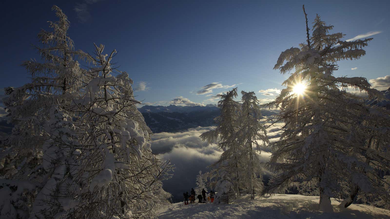 Scientists and media prepare to leave the site of a failed attempt to artificially trigger an avalanche down a mountain side on a cold winter day at the Vallee de la Sionne in Anzere.