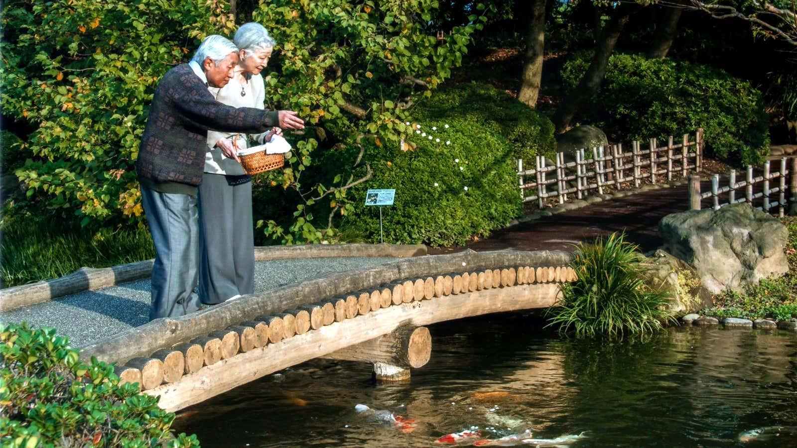 Emperor Akihito and empress Michiko feed carp at the Imperial Palace.