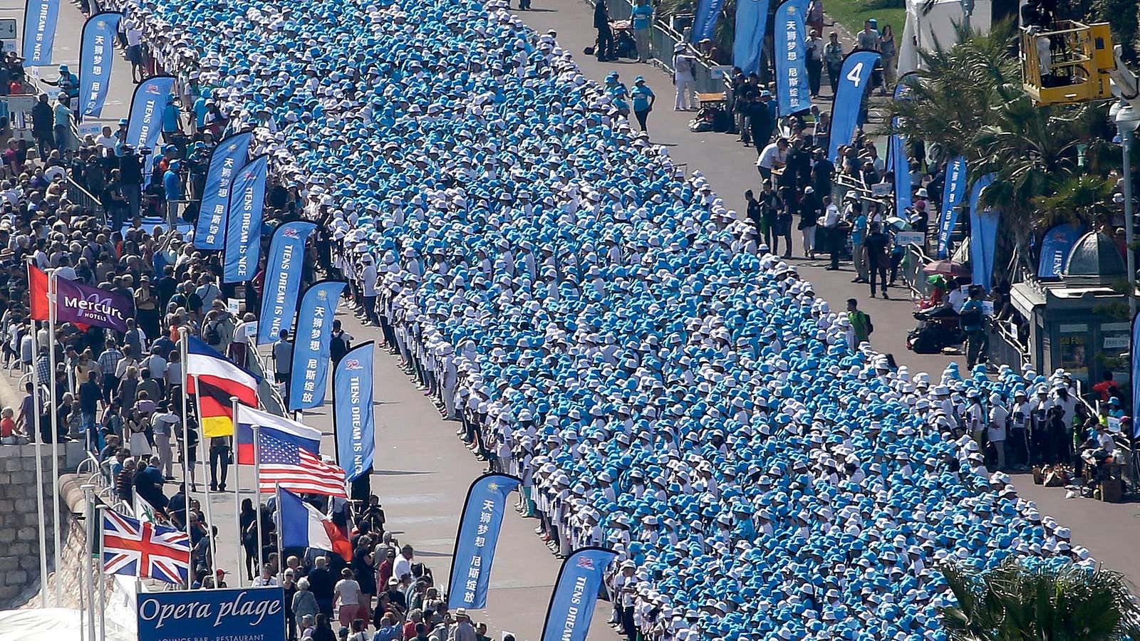 Tiens Group employees parade down a street in Nice.