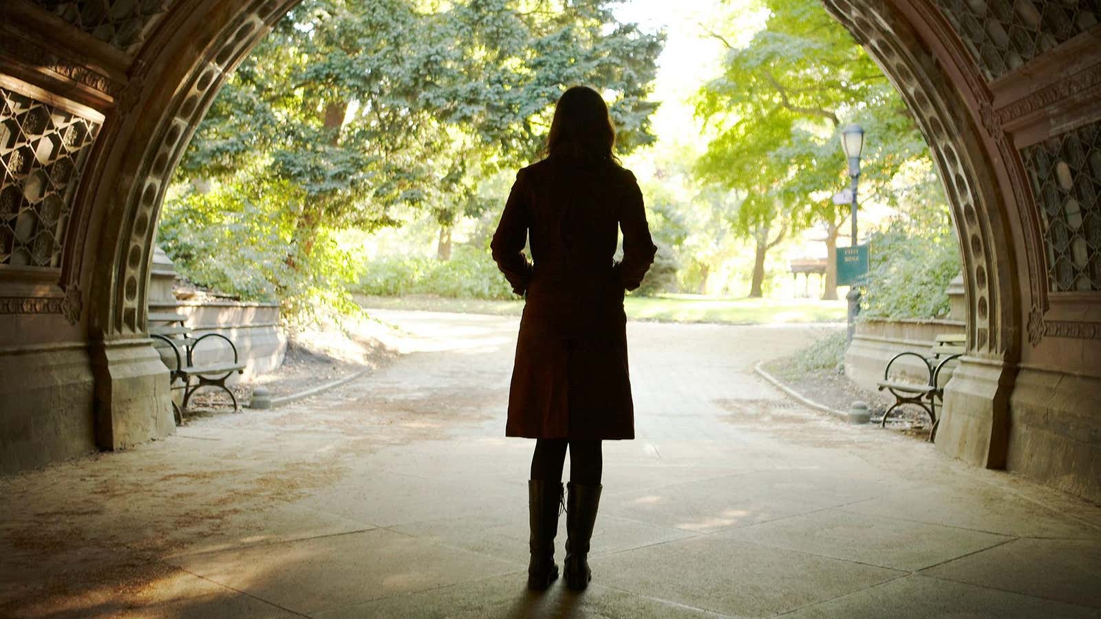 Woman walking through tunnel