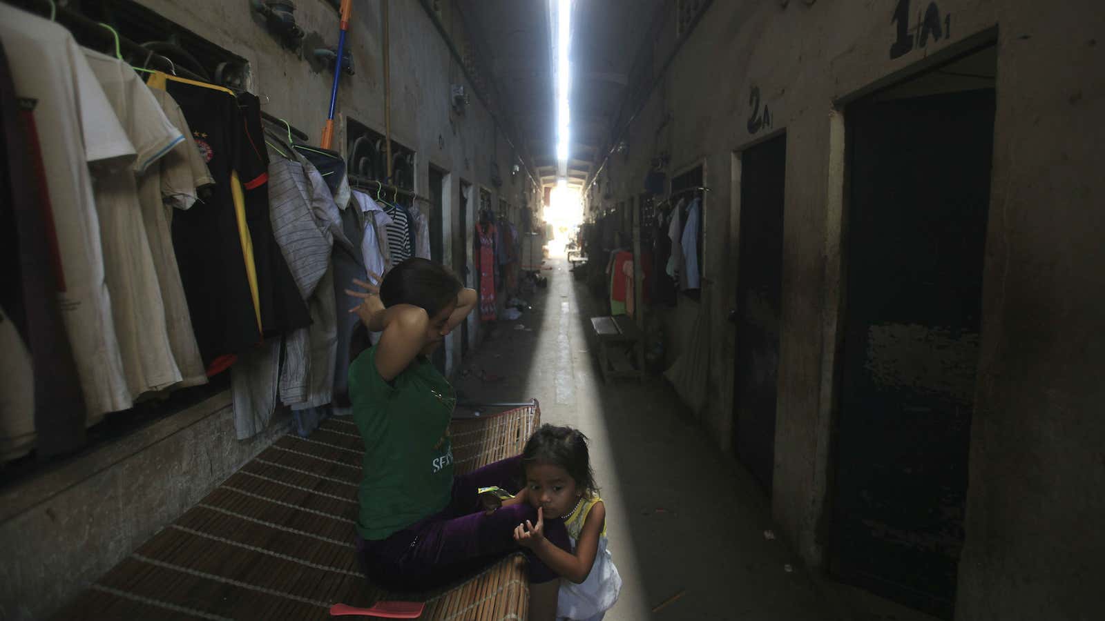 A mother and daughter outside a building that is home to many garment workers on the outskirts of Phnom Penh.