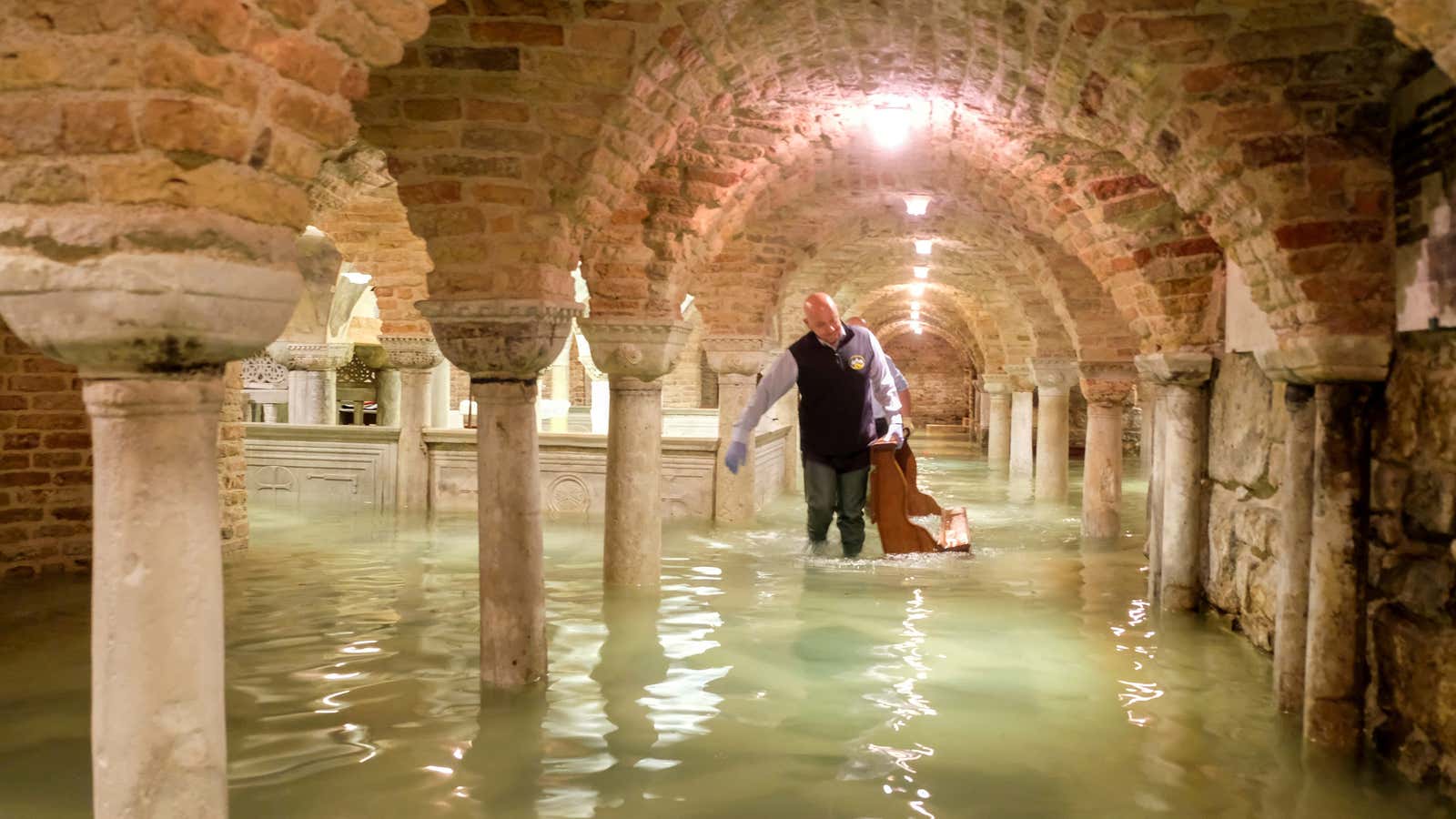 A man wades in the flooded crypt of St Mark’s Basilica during a period of exceptionally high water levels in Venice, Italy November 13, 2019.