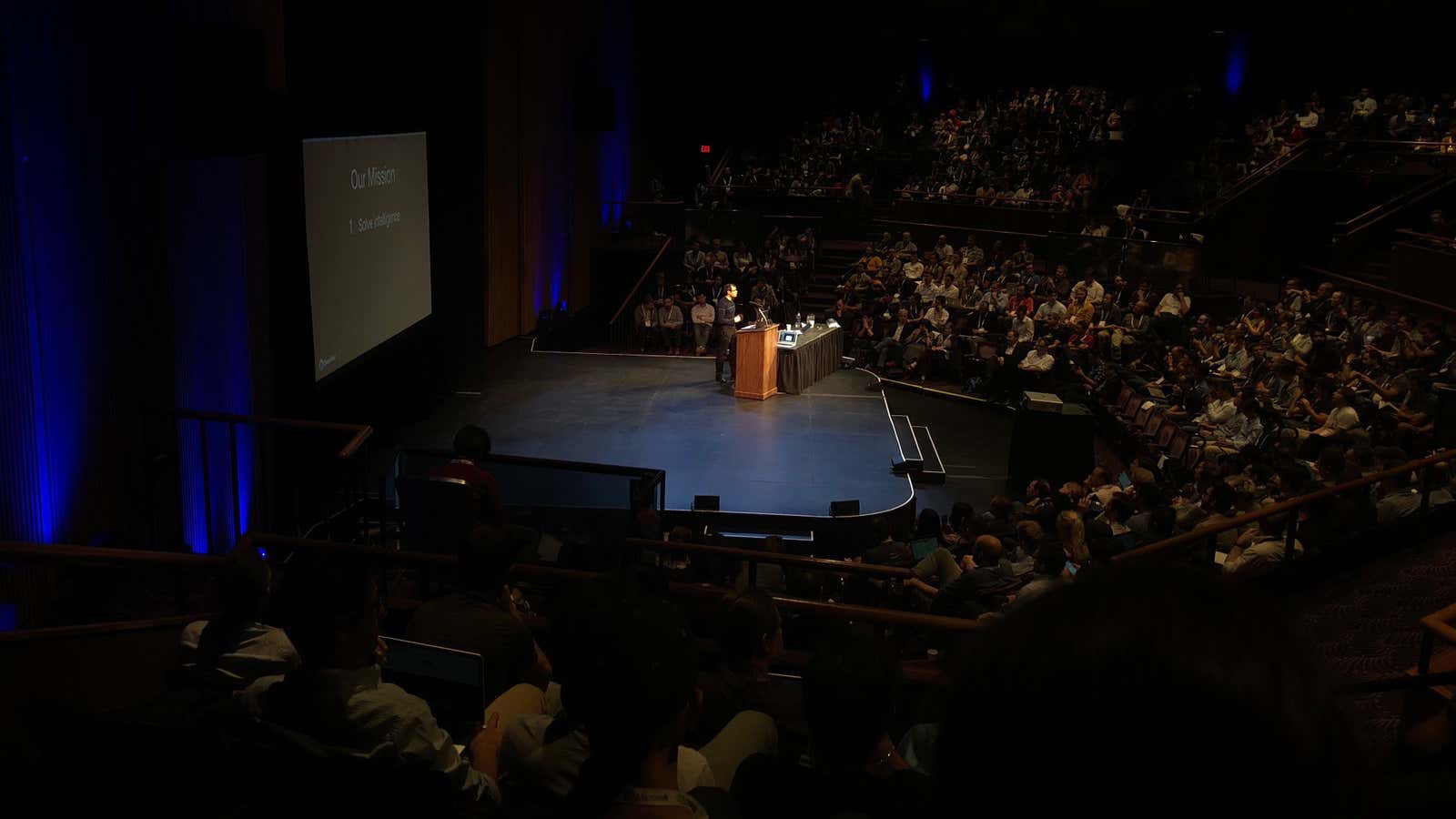 Researchers packed into an auditorium to hear DeepMind co-founder Demis Hassabis speak.