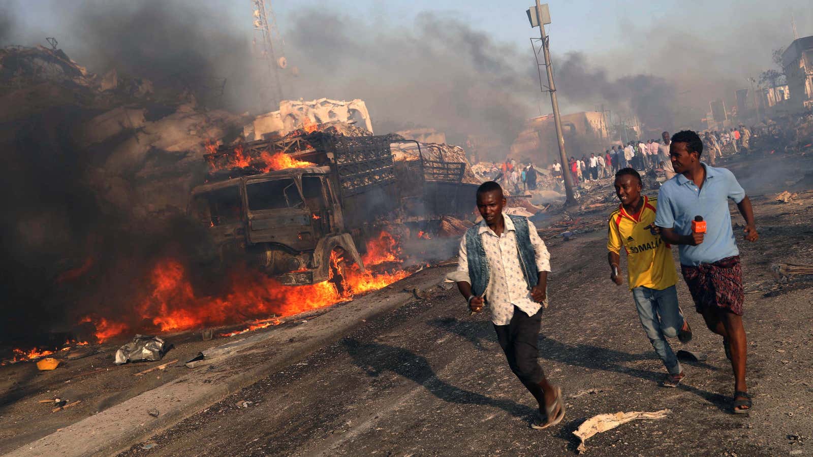 Civilians evacuate from the scene on Oct. 14.