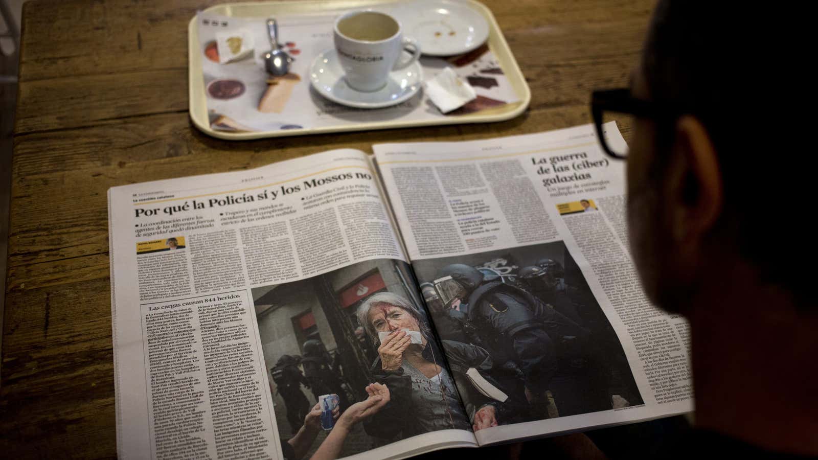 A man reads a newspaper featuring the news following a disputed referendum marred by violence in Barcelona, Spain, Monday, Oct. 2, 2017. Catalan leaders accused…